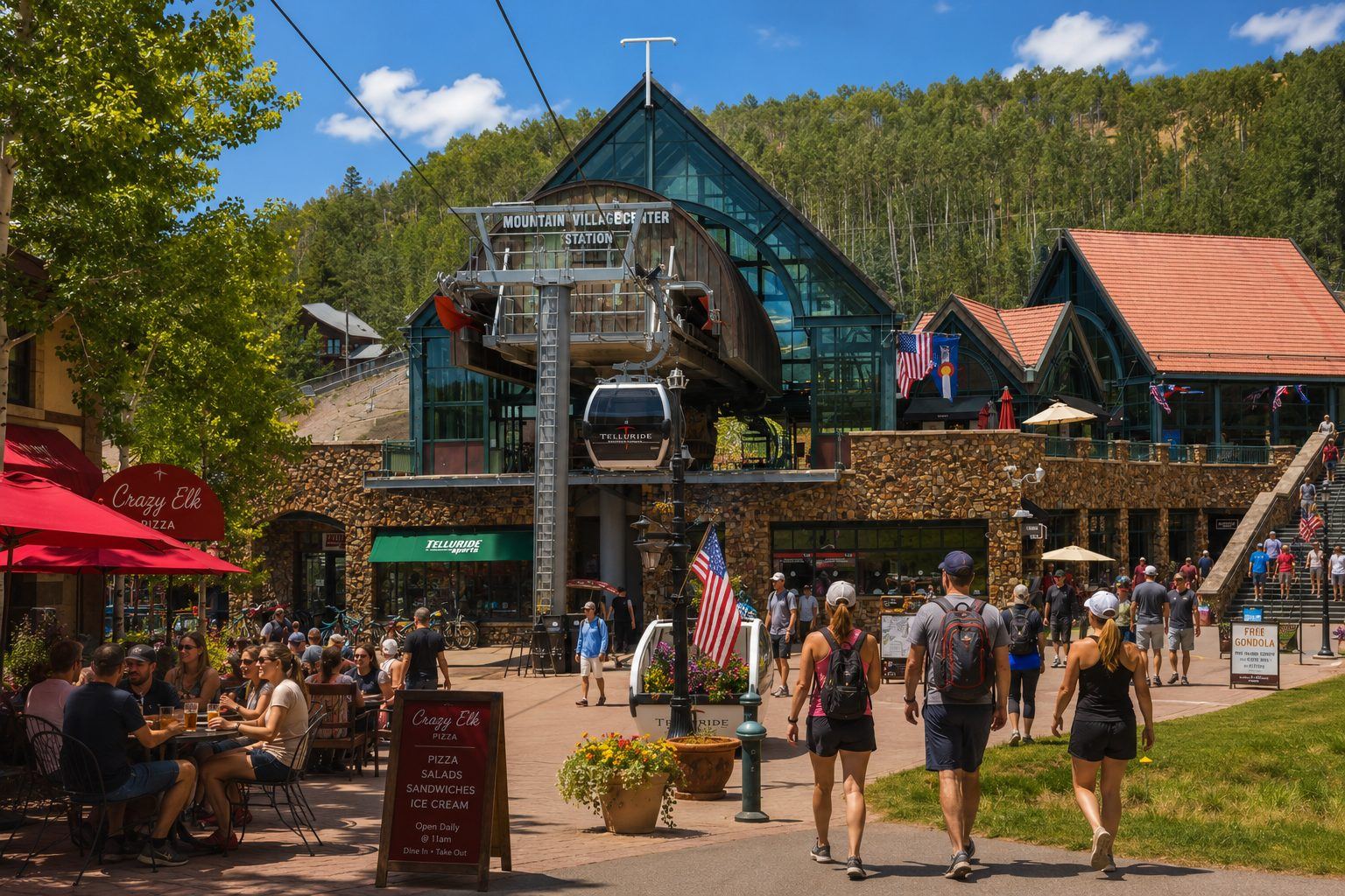 Mountain Village Center Station gondola building with Crazy Elk Pizza patio and sign in the foreground