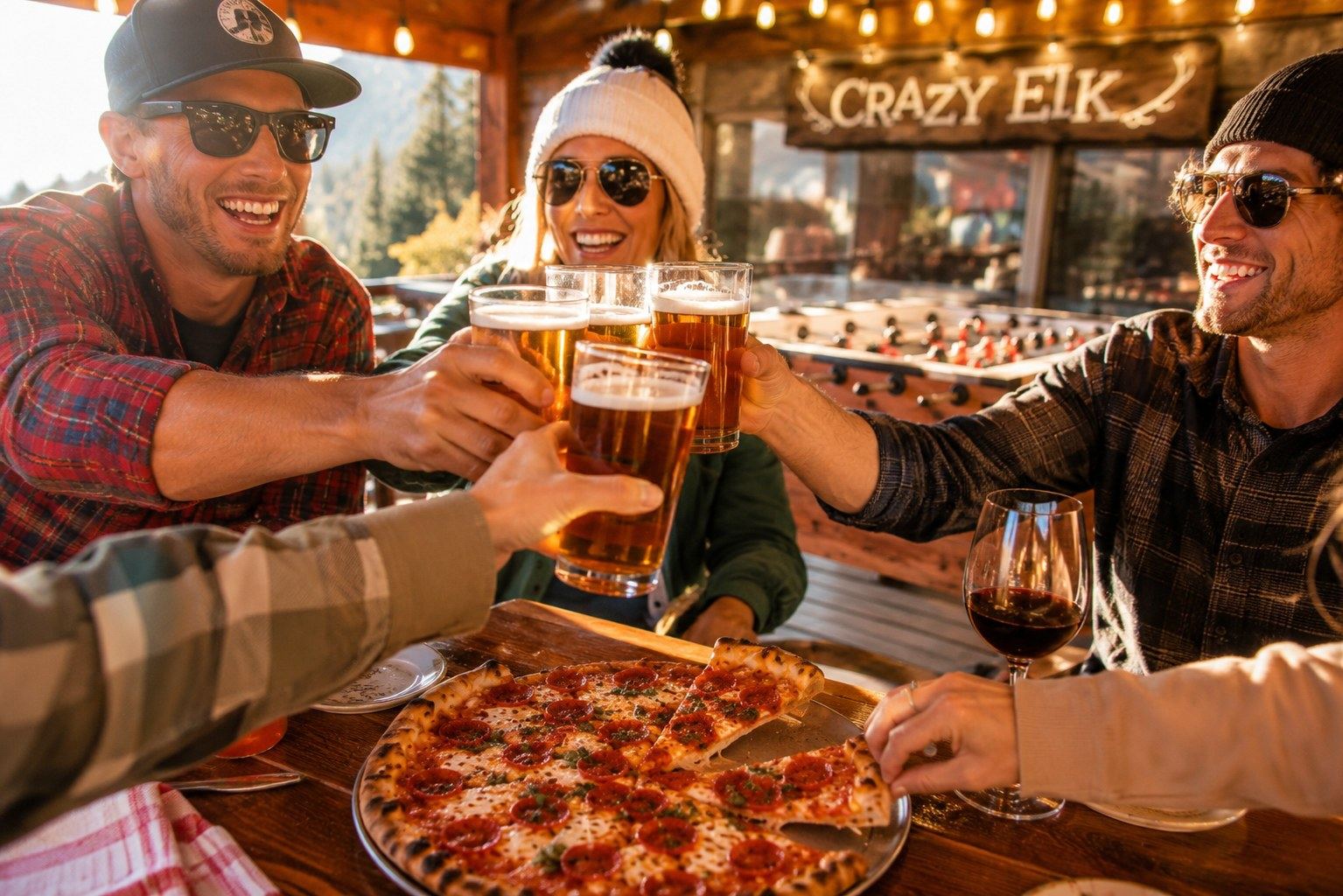 Friends toasting with beer and wine over pizza at Crazy Elk Pizza