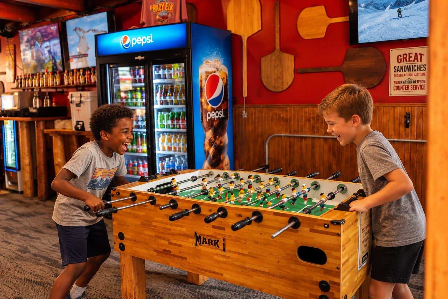 Kids playing foosball at Crazy Elk Pizza